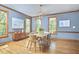 Charming dining room features modern table, wood floors and decorative artwork at 8407 Millers Bnd, Bahama, NC 27503
