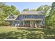Charming two-story home with a welcoming front porch and lush green lawn at 8407 Millers Bnd, Bahama, NC 27503