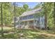 Lovely two-story home with a welcoming porch, surrounded by mature trees at 8407 Millers Bnd, Bahama, NC 27503