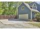 Home's exterior showcases a spacious garage, a paved drive, and manicured lawn at 8407 Millers Bnd, Bahama, NC 27503