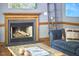 Living room fireplace with logs, stylish decor, and seating nearby at 8407 Millers Bnd, Bahama, NC 27503