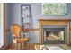 Living room fireplace with decorative shelves, seating, and natural light at 8407 Millers Bnd, Bahama, NC 27503