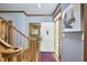 Bright foyer with hardwood floors, elegant staircase, and modern artwork at 8407 Millers Bnd, Bahama, NC 27503