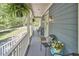 Relaxing front porch with comfortable chairs, potted plants, and a tranquil outdoor setting at 8407 Millers Bnd, Bahama, NC 27503