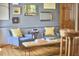 Hallway features cozy seating with chairs, a bench, and walls adorned with colorful artwork at 8407 Millers Bnd, Bahama, NC 27503
