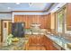 Spacious kitchen features wood cabinets, granite counters, stainless steel appliances, and an island with seating at 8407 Millers Bnd, Bahama, NC 27503