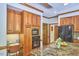 Gourmet Kitchen with granite counters, wood cabinets and trim, and stainless steel appliances at 8407 Millers Bnd, Bahama, NC 27503