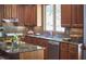 Kitchen features wood cabinets, granite counters, stainless steel appliances, and a bright window at 8407 Millers Bnd, Bahama, NC 27503