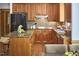 Well-appointed kitchen features wood cabinets, granite counters, tile backsplash, and black stainless steel appliances at 8407 Millers Bnd, Bahama, NC 27503