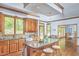 Spacious kitchen features wood cabinets, granite counters, stainless steel appliances, and an island with seating at 8407 Millers Bnd, Bahama, NC 27503