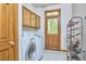 Functional laundry room with washer, dryer, storage cabinets, and shoe rack at 8407 Millers Bnd, Bahama, NC 27503
