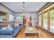 Open living room with hardwood floors, stylish seating, and doors to a deck at 8407 Millers Bnd, Bahama, NC 27503