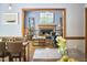 View from the dining room shows an inviting living room with fireplace, wood trim, and hardwood floors at 8407 Millers Bnd, Bahama, NC 27503