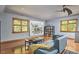 Living area showcasing neutral walls, hardwood floors, and a large art piece above the base trim molding at 8407 Millers Bnd, Bahama, NC 27503