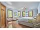 Bright main bedroom with hardwood floors, large windows, a dresser, and comfortable decor at 8407 Millers Bnd, Bahama, NC 27503