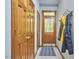 Practical mud room with ample storage cabinets, coat racks, and a blue patterned rug near an exterior door at 8407 Millers Bnd, Bahama, NC 27503