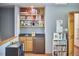 Cozy wet bar with a small refrigerator and display shelves with books and decor at 8407 Millers Bnd, Bahama, NC 27503