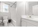 Bright bathroom featuring a toilet, shower, vanity, mirror, and a window for natural light at 909 Starkland Way, Holly Springs, NC 27540