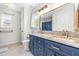 Stylish bathroom with a double vanity, granite countertops, and a large mirror at 909 Starkland Way, Holly Springs, NC 27540