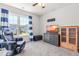 Comfortable bedroom with a large window, gaming chair, and modern entertainment center at 909 Starkland Way, Holly Springs, NC 27540