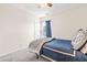 Cozy bedroom with comfortable carpet, a queen size bed, and a window with blue curtains at 909 Starkland Way, Holly Springs, NC 27540