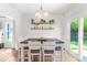 Bright dining room featuring a modern table, stylish chairs, and sliding glass doors at 909 Starkland Way, Holly Springs, NC 27540