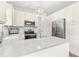 Bright kitchen featuring white cabinets, stainless steel appliances, and modern countertops at 909 Starkland Way, Holly Springs, NC 27540