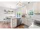Open kitchen with stainless steel appliances, sleek countertops, and an adjoining dining area at 909 Starkland Way, Holly Springs, NC 27540
