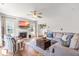 Inviting living room featuring a fireplace, ceiling fan, hardwood floors, and neutral décor with stylish furniture at 909 Starkland Way, Holly Springs, NC 27540