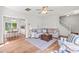 Open-concept living room featuring hardwood floors, comfortable seating, neutral decor, and easy access to the kitchen at 909 Starkland Way, Holly Springs, NC 27540