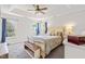 Spacious main bedroom features a tray ceiling, cozy carpet, and bright windows with blue curtains at 909 Starkland Way, Holly Springs, NC 27540