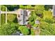 Aerial view of a home with a spacious backyard, a pool, and lush landscaping at 910 S Third St, Mebane, NC 27302
