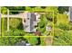 Aerial view of home showcasing the lush, mature trees surrounding the property and backyard patio at 910 S Third St, Mebane, NC 27302