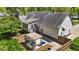 Charming backyard with a pergola-covered seating area, screened-in porch, and lush landscaping at 910 S Third St, Mebane, NC 27302