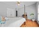 Bedroom featuring a four-poster bed, hardwood floors, and a view of the closet at 910 S Third St, Mebane, NC 27302