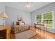 Cozy bedroom featuring hardwood floors, a comfortable daybed, and a well-lit desk area at 910 S Third St, Mebane, NC 27302