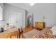 Well-lit bedroom featuring hardwood floors, a double closet, and a classic wooden dresser at 910 S Third St, Mebane, NC 27302