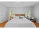 Bright bedroom featuring hardwood floors, a comfortable bed, and abundant natural light from windows at 910 S Third St, Mebane, NC 27302