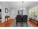 Dining room with hardwood floors, natural light, and a dining table with chairs at 910 S Third St, Mebane, NC 27302