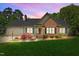Charming single-story home boasts a manicured lawn, brick accents, and a welcoming front porch at 910 S Third St, Mebane, NC 27302