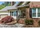 Lovely brick home featuring a covered porch with brick steps and nicely manicured landscaping at 910 S Third St, Mebane, NC 27302