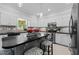 A bright kitchen featuring an island with seating, modern appliances, and stylish decorative accents at 910 S Third St, Mebane, NC 27302
