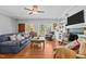 Bright living room features a fireplace, built-in shelves, hardwood floors, and ample natural light at 910 S Third St, Mebane, NC 27302