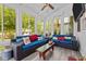 A sunroom featuring lots of windows, wicker sofas, a ceiling fan, and great natural lighting at 910 S Third St, Mebane, NC 27302