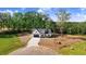 A sunny aerial view showcases the home and the lush green forest at 9200 Otter Ct, Middlesex, NC 27557