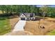 An aerial view showcases the house, long driveway, and surrounding trees at 9200 Otter Ct, Middlesex, NC 27557