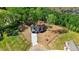 Aerial view of home with large front yard, long driveway, and surrounded by mature trees at 9200 Otter Ct, Middlesex, NC 27557
