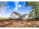 The back exterior showcases a screened in porch and serene backyard at 9200 Otter Ct, Middlesex, NC 27557