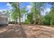Large backyard with trees and partially-covered ground, ideal for outdoor activities and relaxation at 9200 Otter Ct, Middlesex, NC 27557