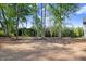 Large, spacious backyard with mature trees providing shade and privacy at 9200 Otter Ct, Middlesex, NC 27557